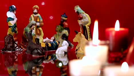 Christmas-nativity-scene-with-candles-on-red