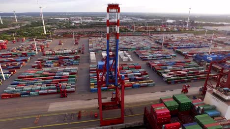 Hamburg-container-port-with-ships-and-cranes-at-sunset