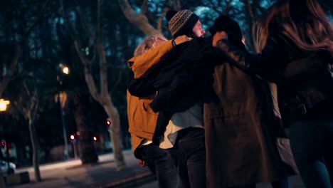Young-happy-couples-embracing-while-taking-a-night-walk-outside