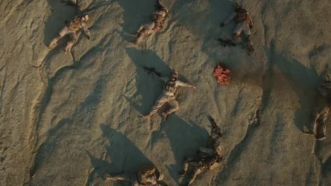 Flying-over-Group-of-Dead-Soldiers-in-Desert-Area.-Zooming-In.