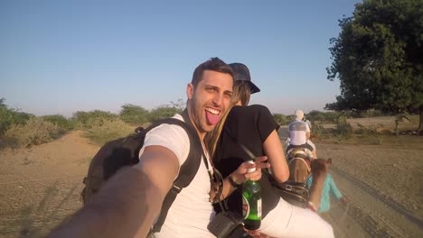 Couple-taking-a-selfie-in-a-camel-riding-in-desert