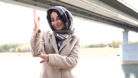 Beautiful-Muslim-girl-raising-hand