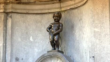 Manneken-Pis-statue-in-Brussels.-Statue-of-a-pissing-boy-in-a-beautiful-summer-day-in-Brussels,-Belgium.