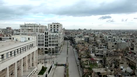 Aerial-view-of-a-road-surrounded-by-ravaged-houses-and-buildings