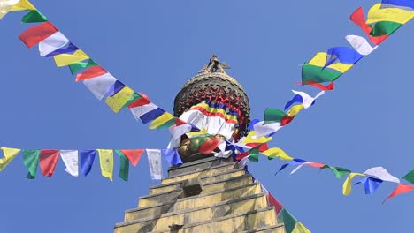 Colorful-flags-flying-from-Buddhist-Stupa-in-Kathmandu-valley,-Nepal