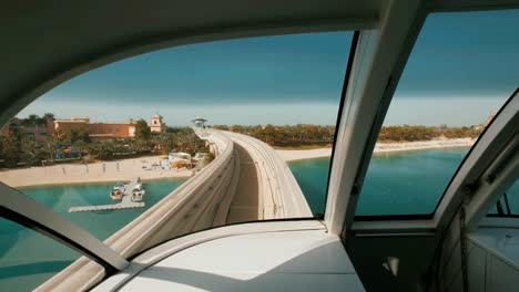 view-from-windshield-of-wagon-of-monorail-train-in-Dubai,-moving-over-Palm-Jumeirah