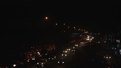 Time-lapse-shot-of-traffic-on-road-in-a-city-at-night,-Delhi,-India