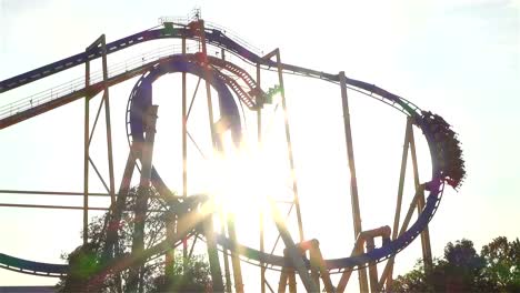 SLOW-MOTION:-Extreme-roller-coaster-ride-at-golden-sunset