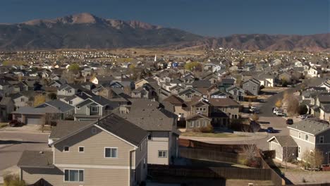 AERIAL-Luxury-row-houses-in-suburban-town-with-Rocky-Mountains-in-the-background