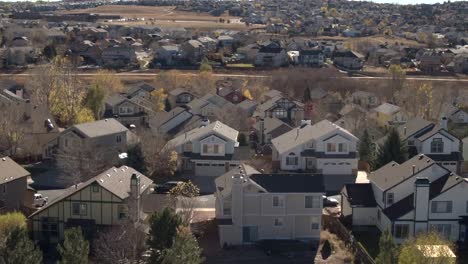 AERIAL,-CLOSE-UP:-Luxury-row-houses-with-beautiful-backyards-in-sunny-suburbs