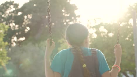 Children-swinging-together-at-a-public-playground