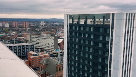 Small-traditional-redbrick-church-is-dwarfed-by-a-modern-towerblock