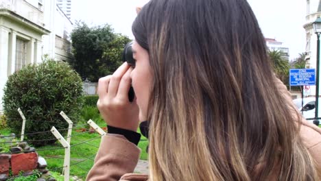 Young-Woman-photographer-taking-pictures-of-Moai-statue-at-Vina-del-Mar,-Chile