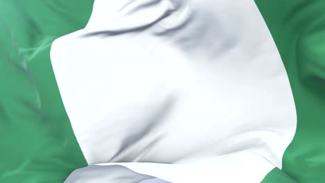 Flag-of-Nigeria-waving-at-wind-in-slow-in-blue-sky,-loop