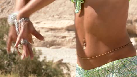 Beautiful-female-dancer.-Belly-dance.-Desert.-Sexy-green-dress-dancing.-Close-up