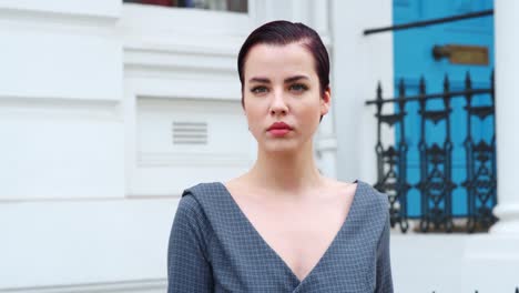 Fashion-Conscious-Young-Woman-Standing-Outdoors-On-City-Street