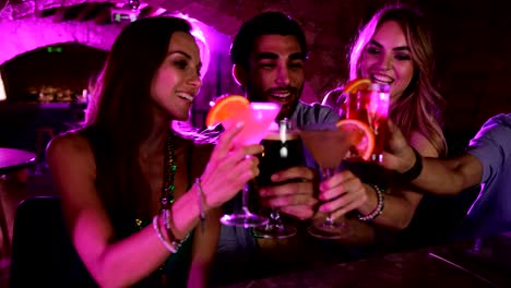 Young-multi-ethnic-friends-celebrating-Mardi-Gras-at-New-Orleans-bar