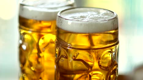 Two-full-glasses-of-cold-beer.-Close-up,-visible-foam-and-air-bubbles-in-the-glass.-Glass-of-glasses-fogged-up