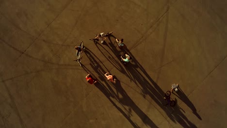 Kids-on-wheeled-vehicles.-They-stands-in-circle-and-greeting