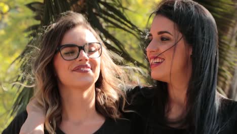 Two-girlfriends-together-walking-at-the-park-embracing-each-other.-LGBT-couple