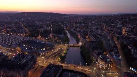 sunset-illuminated-zurich-city-center-riverside-aerial-panorama-4k-switzerland