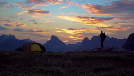 A-man-near-the-tent-looks-at-the-dawn