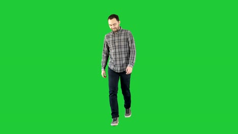 Young-man-walking-in-a-good-mood-on-a-Green-Screen,-Chroma-Key