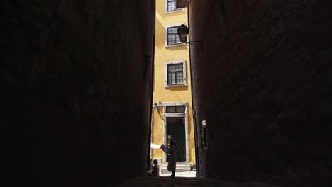 Woman-walking-on-narrow-street-with-map