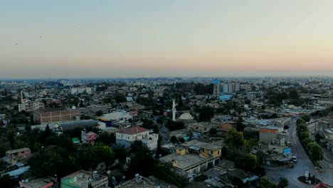 Flight-above-Muslim-town-with-mosque-minaret-and-residential-buildings.