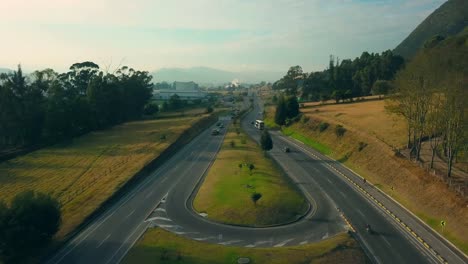 Aerial-view-of-a-highway-in-Colombia-including-mountains,-traffic-and-the-country-side