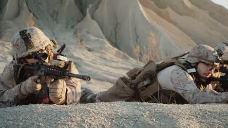 Group-of-Soldiers-Lie-Down-on-the-Hill,-Aim-through-the-Assault-Rifle-Scope-in-Desert-Environment.-Slow-Motion.