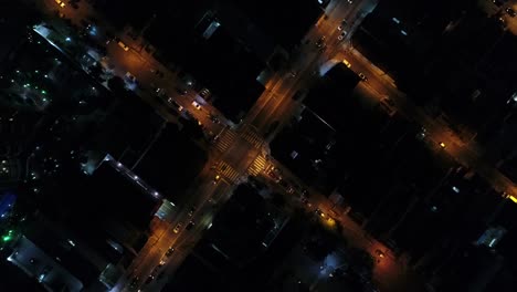 Top-View-of-Intersection,-Rooftops-and-illuminated-streets