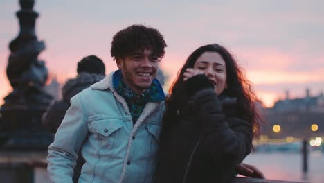 Couple-Walking-Along-South-Bank-On-Winter-Visit-To-London