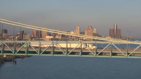 AERIAL:-Freight-container-semi-trucks-hauling-goods-across-the-highway-bridge