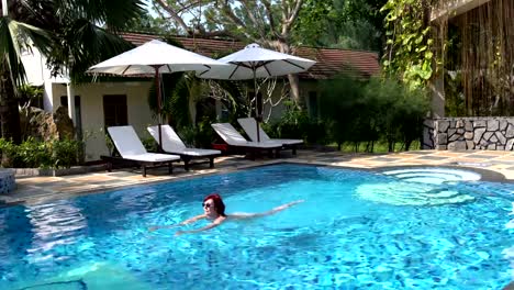 The-woman-swims-in-the-open-air-pool