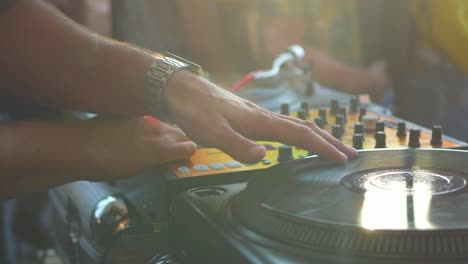 close-up-dj-hand-scratching-vinyl-record-on-turntable-on-a-party