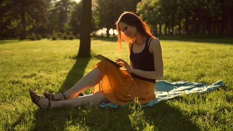 Handsome-sexy-female-using-tablet-computer-outdoors