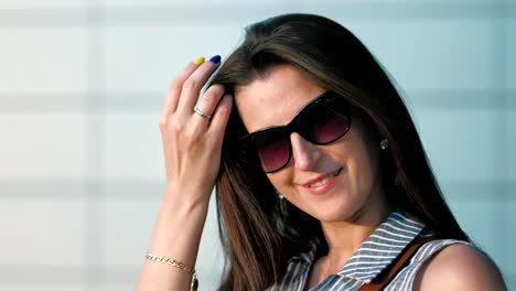 Close-up-face-of-attractive-young-businesswoman-in-sunglasses-admiring-sunset-or-sunrise