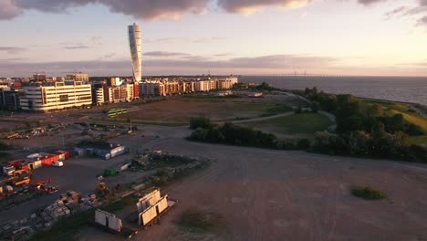 Aerial-view-of-Malmo-city-buildings-at-sunset.-Industrial,-construction-area