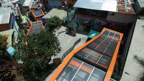 View-of-outdoor-escalators-in-Comuna-13-Medellin-Colombia,-wide-shot-panning-and-tilting