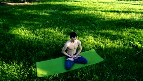 Young-bare-chested-man-doing-yoga