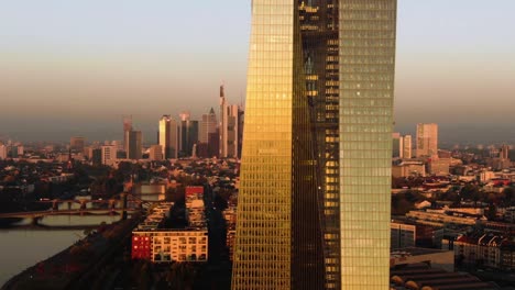 Frankfurt-ECB-Skyline-Aerial-Shot-at-early-sunrise-reflecting-sun