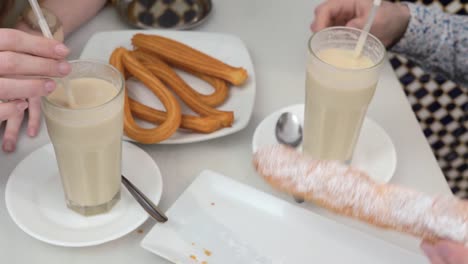 Horchata-with-fartons-and-churros-in-Valencian-cafe,-Spain