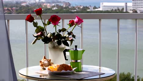 Delicious-breakfast--with-coffee-fresh-croissants-and-slice-of-orange-fruit-on-balcony