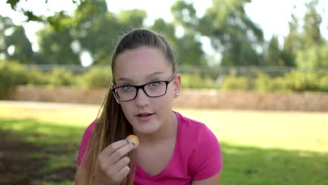 Happy-teenage-girl--closing-her-eyes-with-round-cookies-and-making-fun