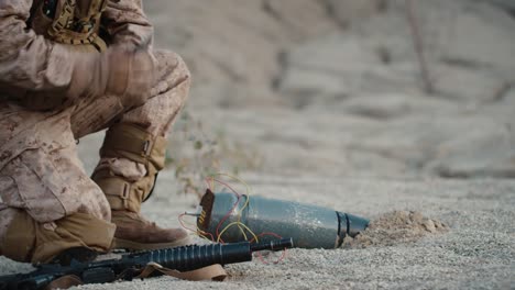 Soldier-Defusing-a-Bomb-by-Cutting-a-Wire-During-Military-Operation-in-Desert-Environment