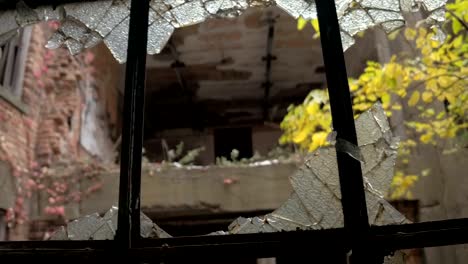 FPV:-Looking-out-the-broken-window-at-abandoned-building-in-decaying-ghost-town