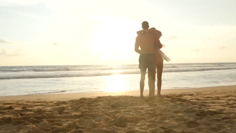 Happy-couple-kissing-and-hugging-each-other-at-the-sea-beach-at-sunset.-Young-man-and-woman-in-love-having-fun-together-at-beautiful-ocean-shore-during-summer-holidays-or-vacations.