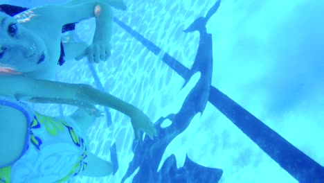 Underwater-footage-of-kids-jumping-and-diving-in-a-swimming-pool