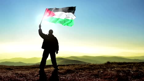 Erfolgreiche-Silhouette-Mann-Sieger-winken-Jordan-Flagge-auf-die-Bergspitze,-Cinemagramm-LOOP-Hintergrund